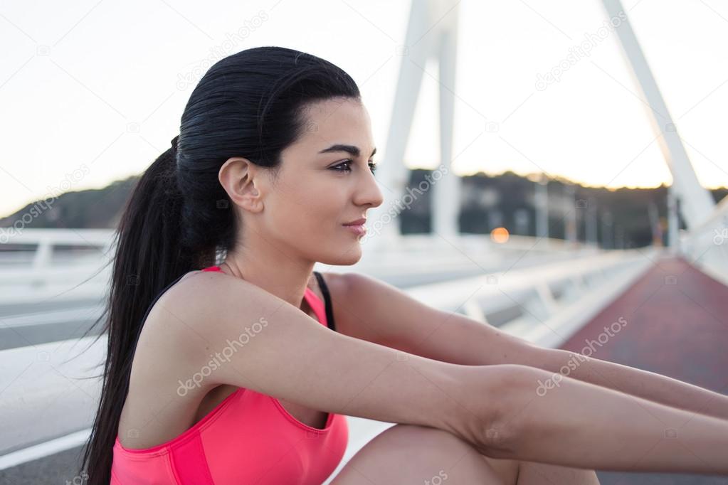 Sportswoman relaxing after physical exercise