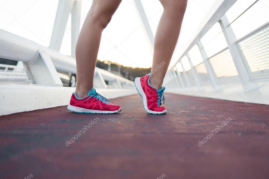Woman's legs in running shoes