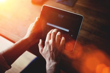 Man's hands working on touch pad