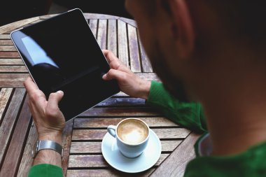 Young man holding touch pad