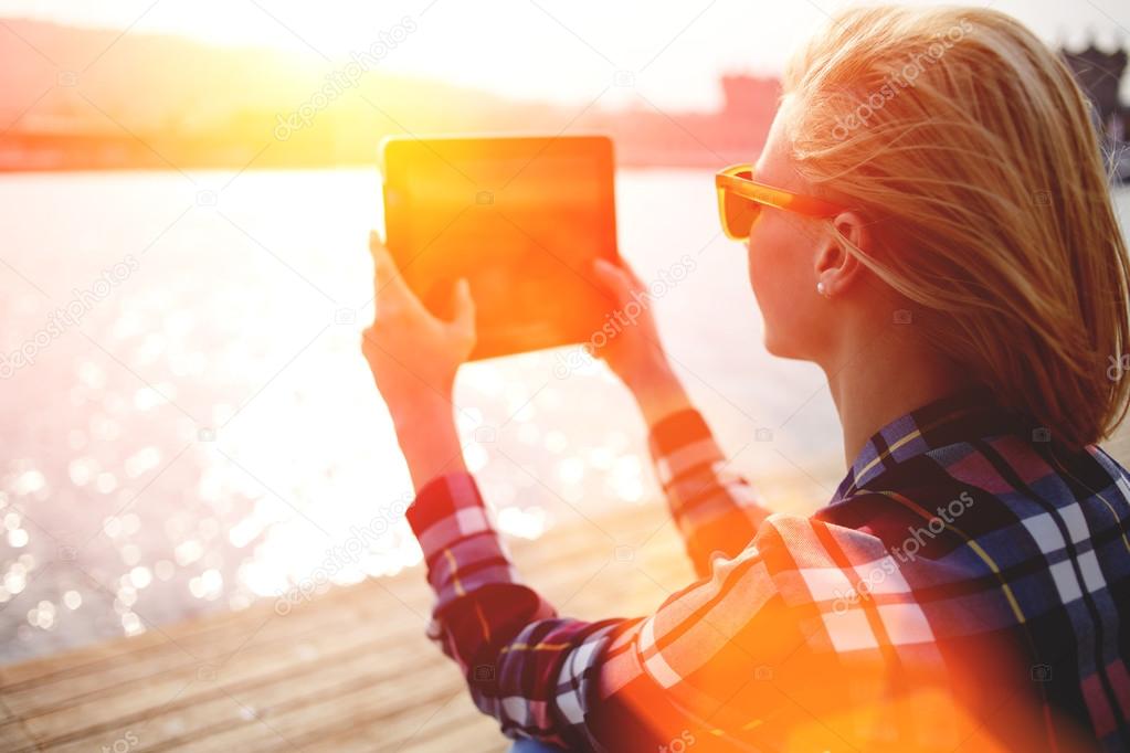 Woman taking photo with touch pad