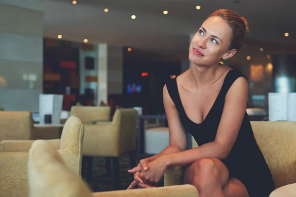 Young dreamy businesswoman in cozy cafe — Stockfoto