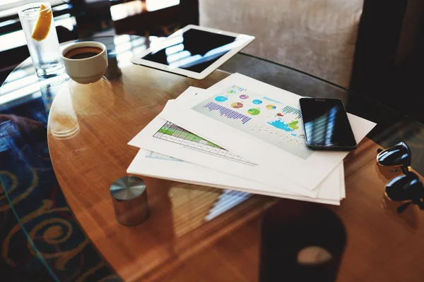 Digital tablet and mobile phone on table