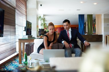 Two business colleagues working on net-book