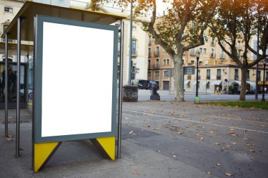 Illuminated blank billboard in urban setting