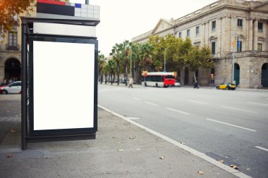 Illuminated blank billboard in urban setting