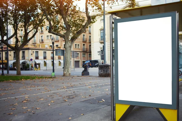 Illuminated blank billboard in urban setting