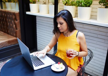 Young trendy woman working on laptop