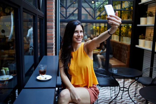 Smiling woman making self portrait — Stock Photo, Image