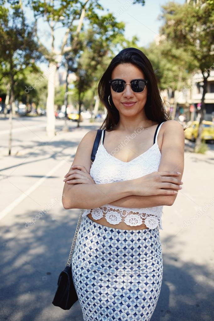 Young trendy woman posing on the street