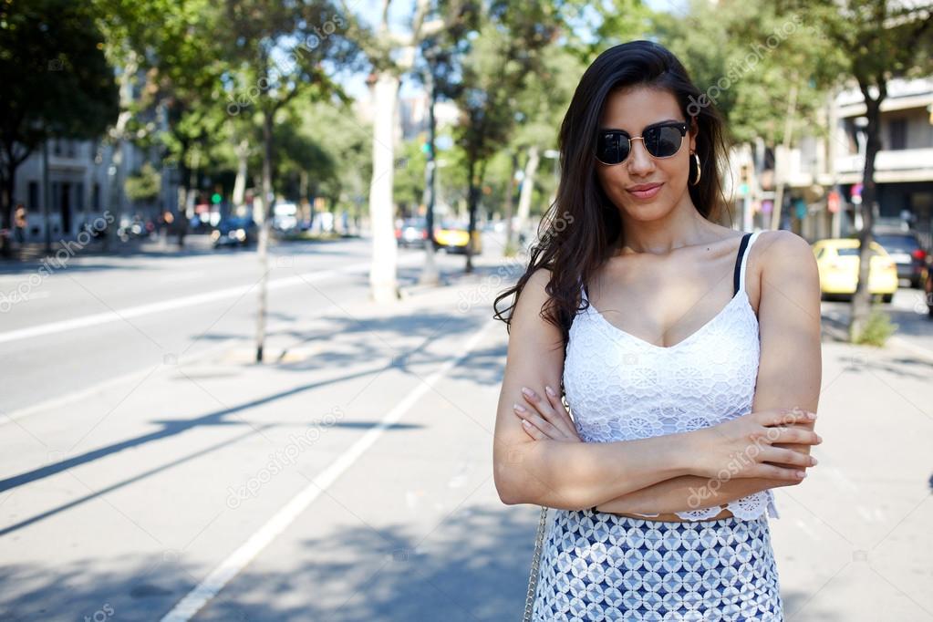 Young trendy woman posing on the street