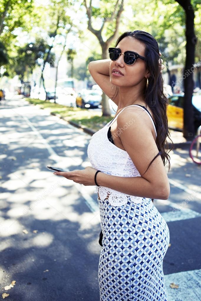 Woman using cell telephone outside