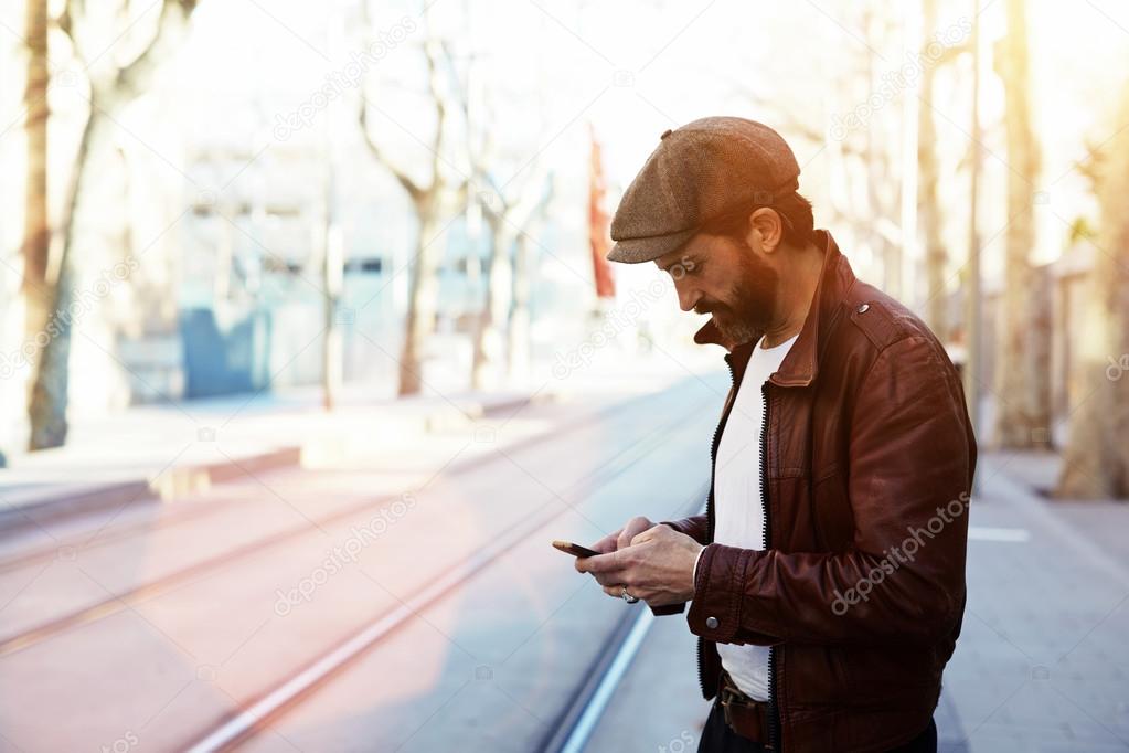 Man with mobile phone in urban setting