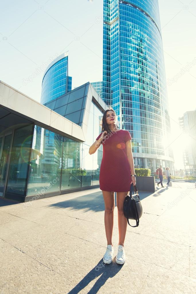 Woman posing near modern office building