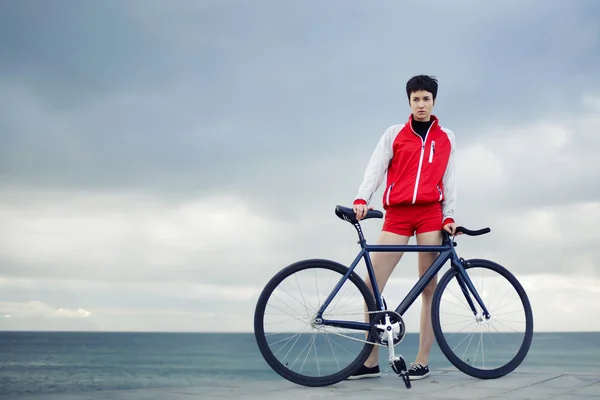 Hipster girl with sports bicycle on pier — Stock Photo, Image