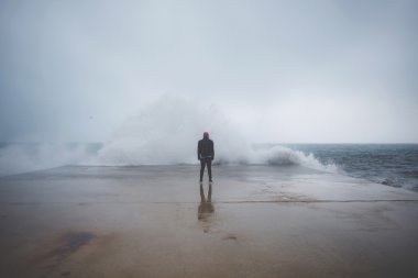 Rear view of man standing on the pier