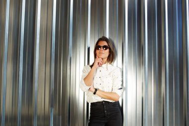 Model in black sunglasses posing outdoors