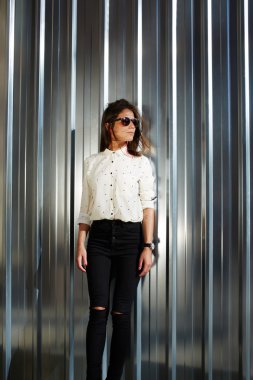 Model in black sunglasses posing outdoors