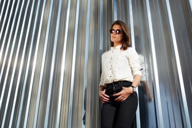 Model in black sunglasses posing outdoors