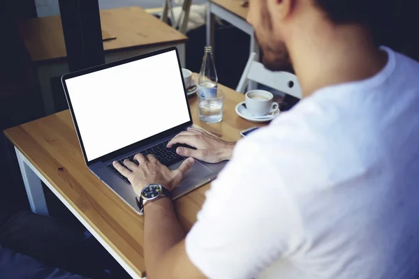 young man keyboarding on net-book