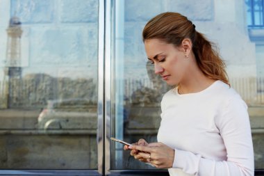 woman reading text messaging on mobile
