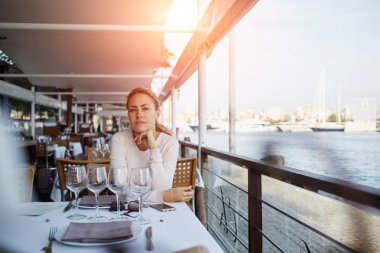 female tourist sitting in sidewalk cafe