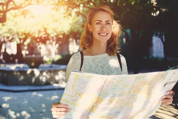 female traveler exploring location map