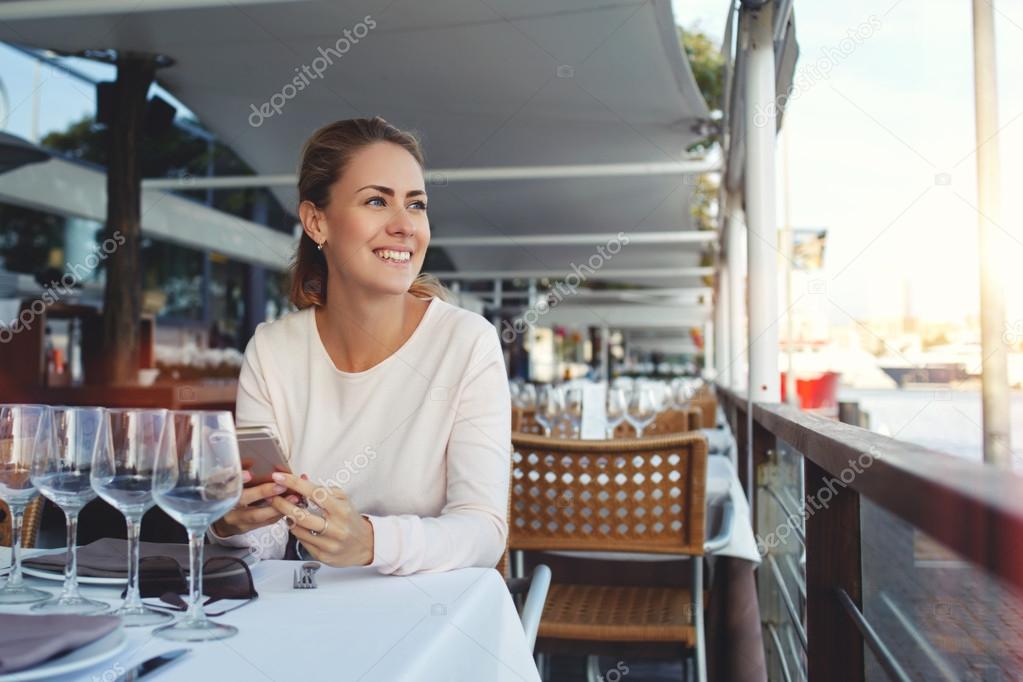 woman sitting with mobile phone