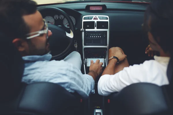 two men sitting in cabriolet car