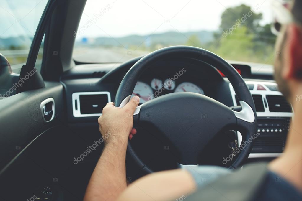 male driver sitting at steering wheel