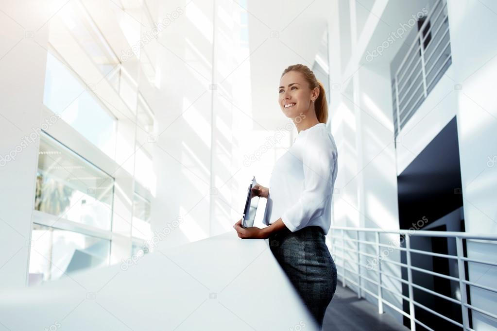 happy businesswoman holding digital tablet