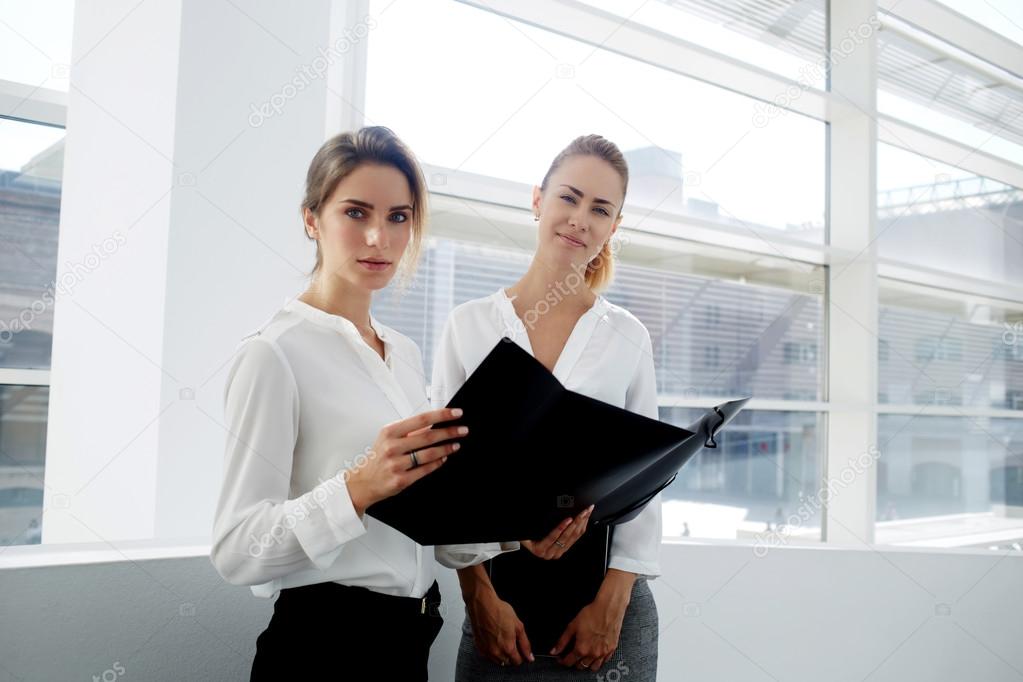 businesswomen considering paper documents