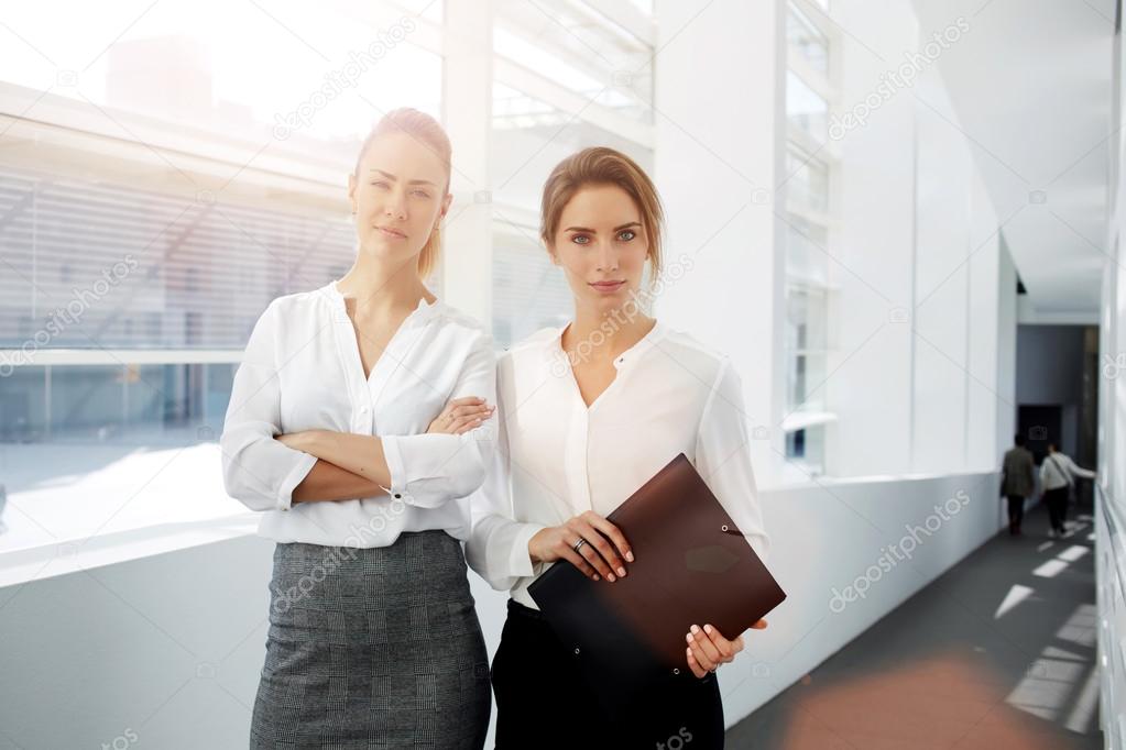 successful women standing in modern office