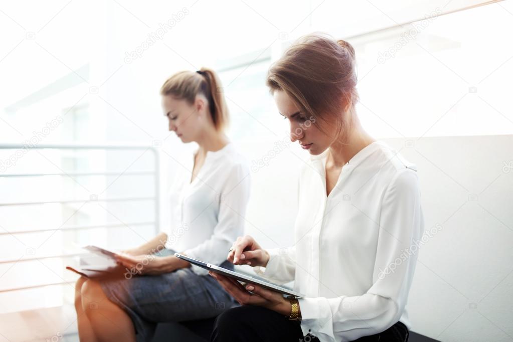 businesswomen with digital tablet and cell telephone