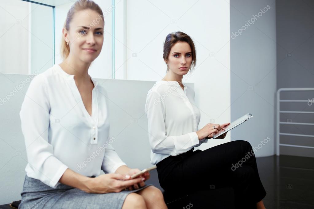 businesswomen with digital tablet and cell telephone