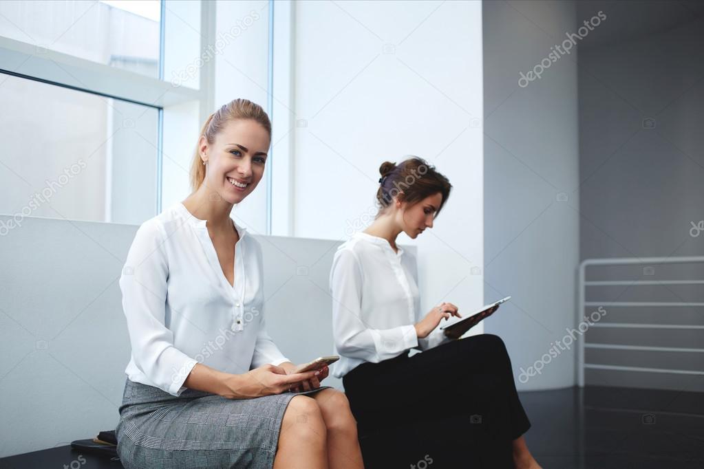 businesswomen with cell telephone and digital tablet