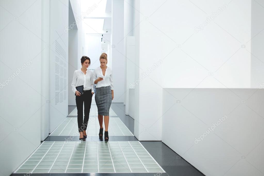 Two businesswomen discussing news