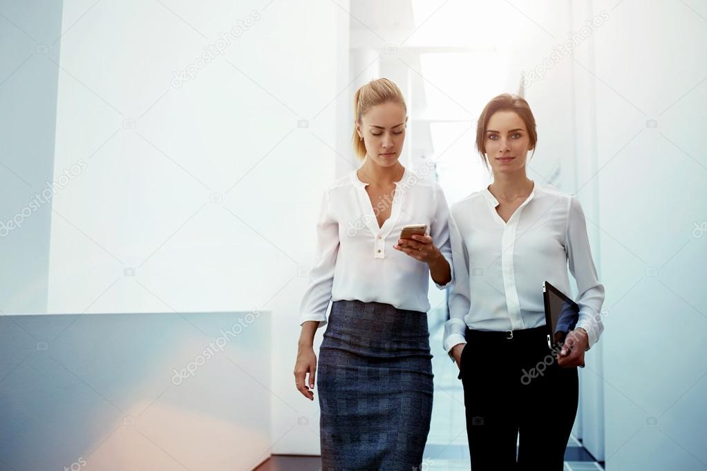 Two businesswomen in modern office interior