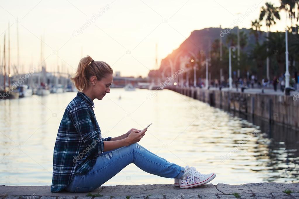 woman reading messaging on mobile phone