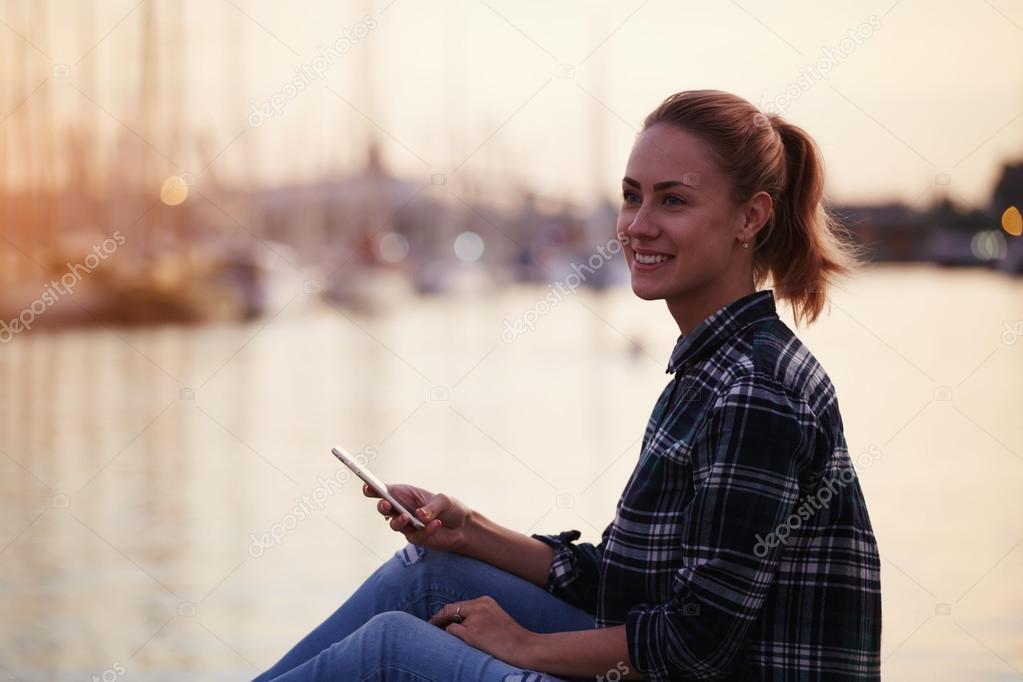 Young woman holding mobile phone