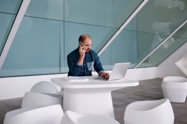 male manager talking on cell telephone
