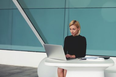 businesswoman keyboarding on laptop