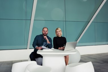 man and woman confident economists