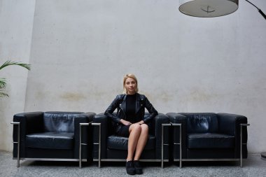 young hipster girl sitting in hallway