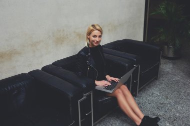 Stylish female student using net-book