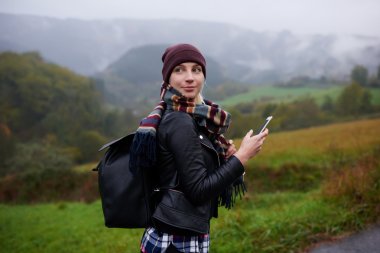 Woman with cell telephone in mountains