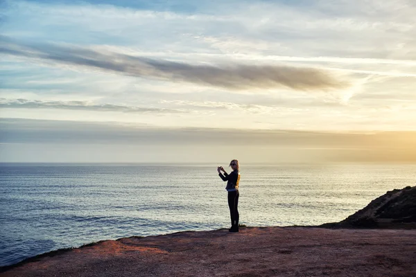 Female taking photo of sea landscape — ストック写真