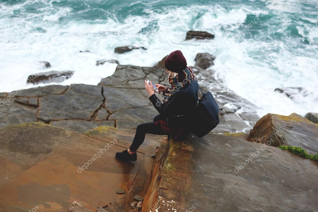 hipster girl using mobile phone outdoors