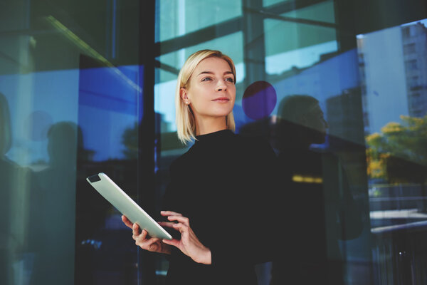 Young businesswoman holding touch pad