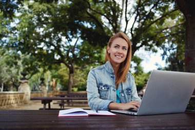 woman preparing coursework on laptop